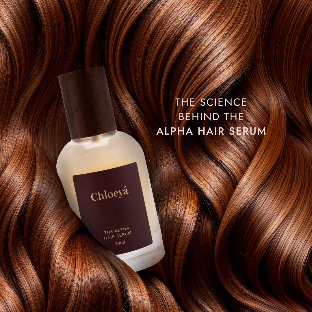 The Alpha Hair Serum resting in a fall of auburn hair